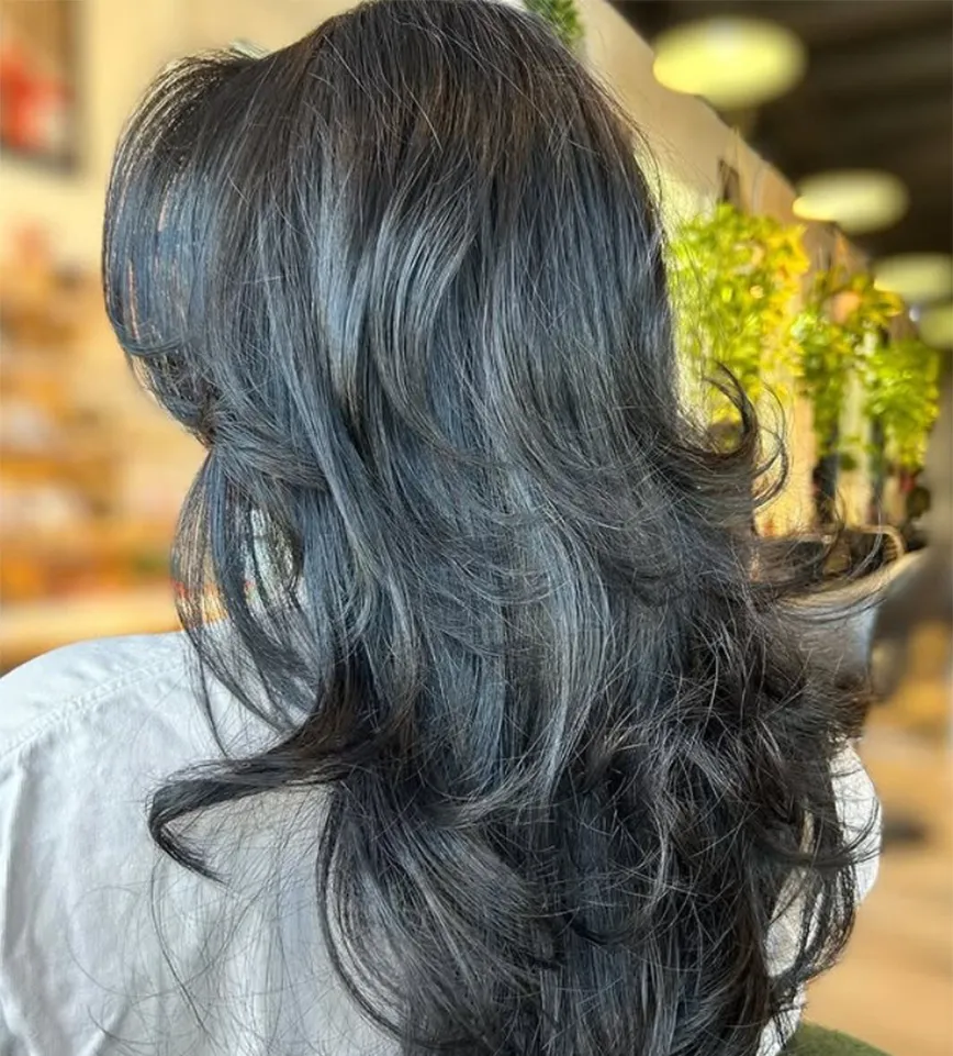 Back view of a person with a dark, layered balayage haircut. - Ka'ton Salon, Fort Lauderdale FL