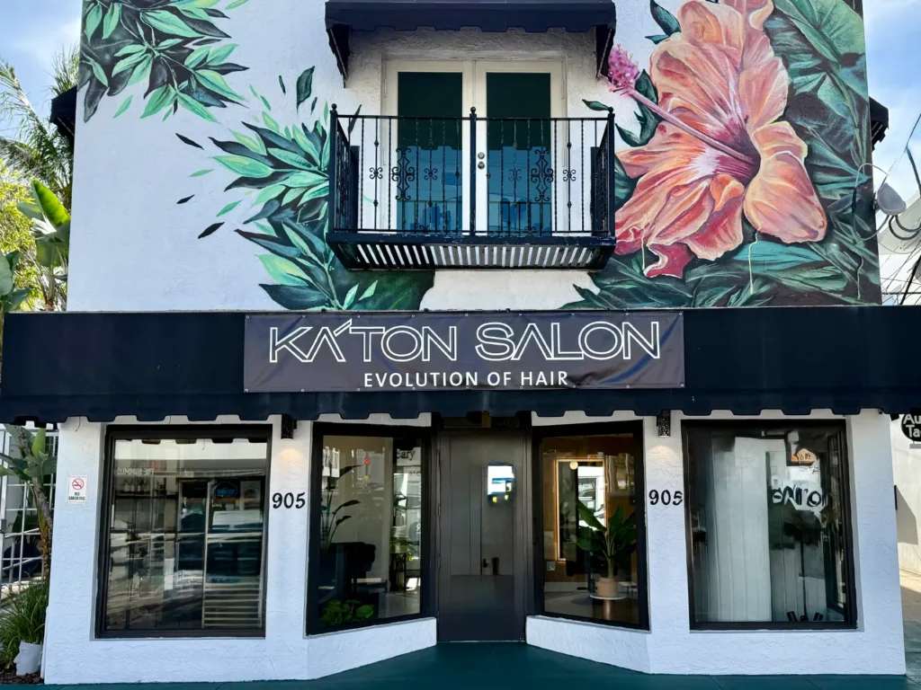 Storefront of Katon Salon, featuring a mural of large hibiscus flowers above the entrance, where clients visit for a professional haircut or balayage. - Ka'ton Salon, Fort Lauderdale FL